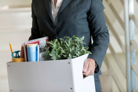worker holding a box with personal items