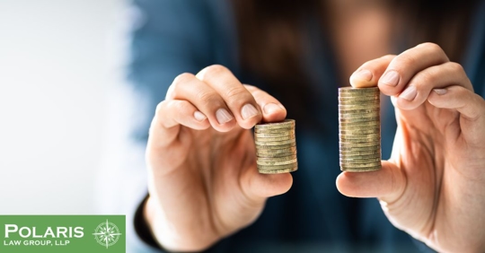 employee holding stacks of coins in both hands