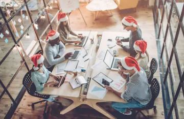 Office workers wearing festive hats