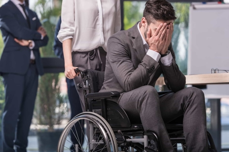 large office meeting with a worker in a wheelchair