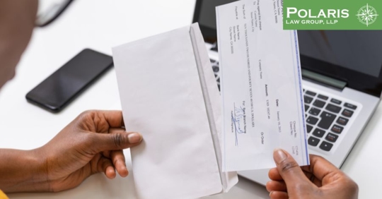 employee holding paycheck